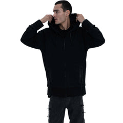 Person wearing a black hoodie, gray pants, and black boots on a white background