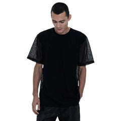Person wearing a black outfit with a t-shirt, pants, and boots on a white background