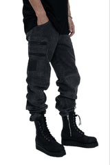 Person wearing dark gray cargo pants and black boots on a white background